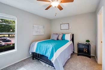 Bedroom with Large Window and Ceiling Fan with Light